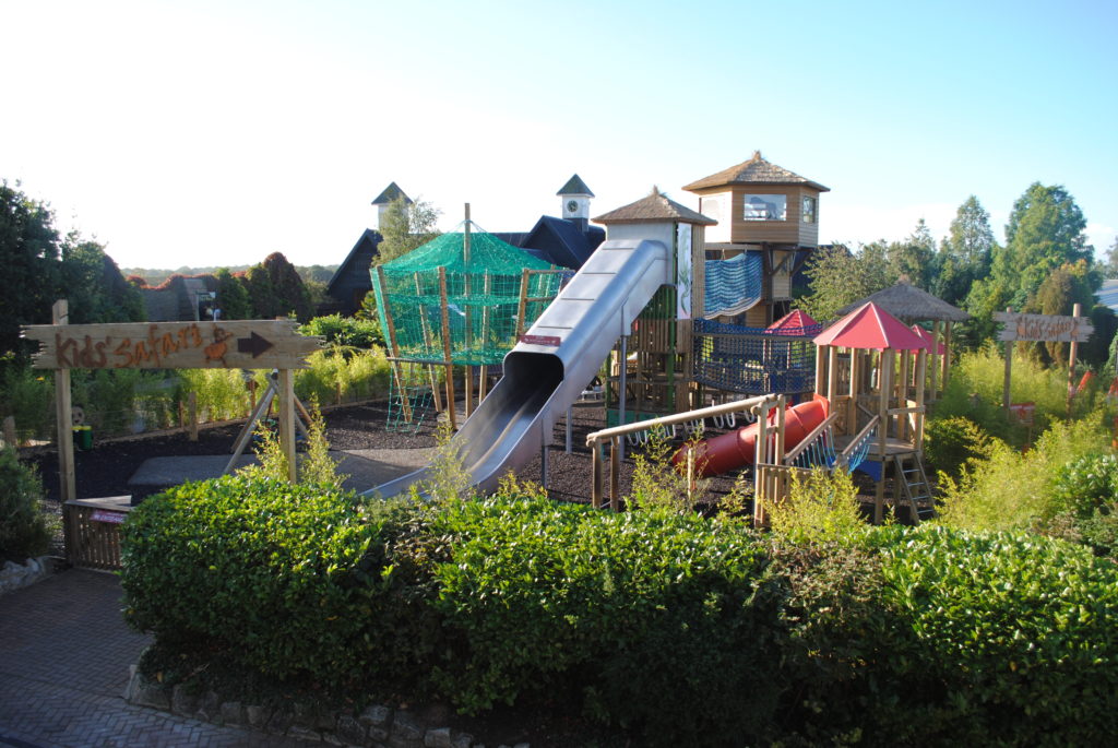 Large outdoor play area with nets and slides